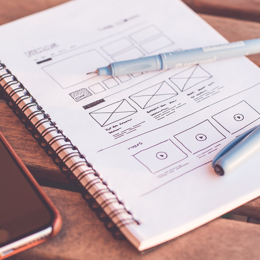 A sketch of a website design on a notebook